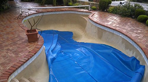 Empty swimming pool before being converted into a rainwater tank